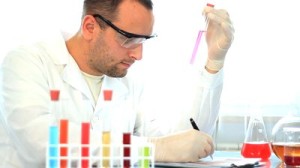 stock-footage-male-scientist-examine-test-tubes-with-chemicals-and-writing-results